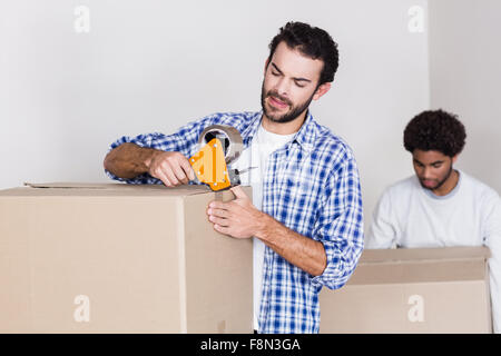 Gay couple closing and holding big boxes Stock Photo