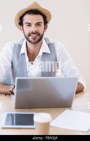 Portrait of smiling man using laptop Stock Photo