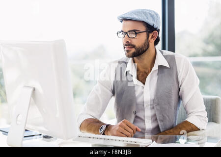 Handsome man looking at computer monitor Stock Photo