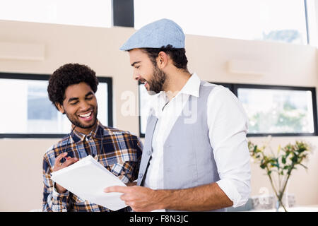 Happy gay couple holding document Stock Photo