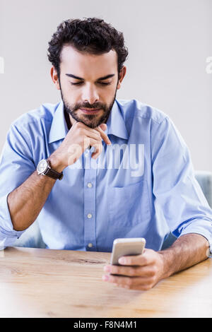 Serious man using smartphone Stock Photo