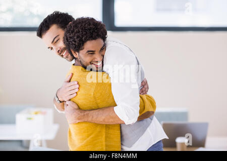 Happy gay couple hugging each other Stock Photo