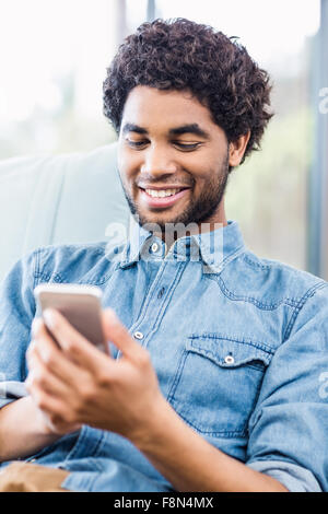 Smiling man using smartphone Stock Photo