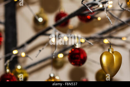 Christmas decorations hanging from contemporary christmas tree Stock Photo