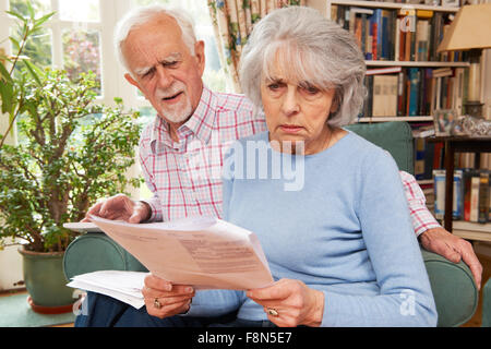 Senior Couple Going Through Finances Looking Worried