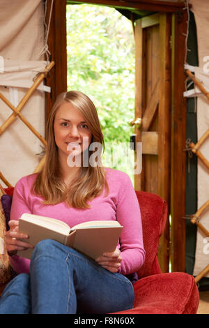 Woman Enjoying Luxury Camping Holiday In Yurt Stock Photo