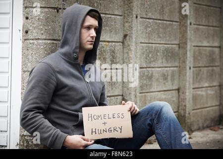 Homeless Young Man Begging On Street Stock Photo