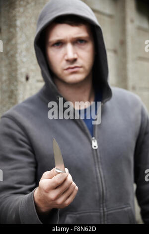 Threatening Looking Man Holding Knife Stock Photo