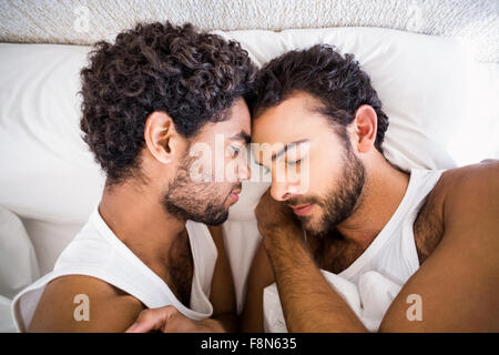 Gay couple sleeping together on bed Stock Photo