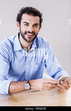 Smiling man using smartphone Stock Photo
