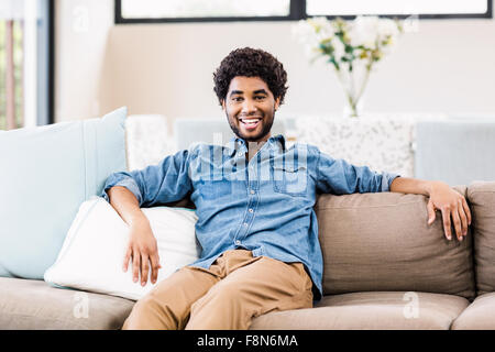 Handsome man on sofa Stock Photo