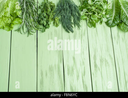 Green herbs on the green wooden background. Stock Photo