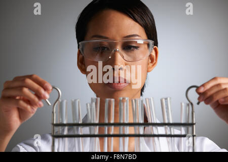 Female Scientist Examines Test Tubes Stock Photo