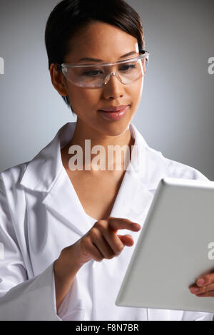 Studio Portrait Of Female Laboratory Worker With Digital Tablet Stock Photo
