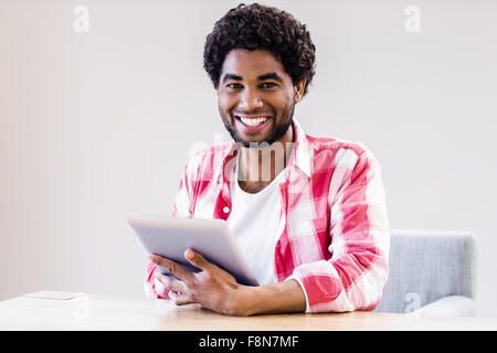 Smiling man using tablet Stock Photo