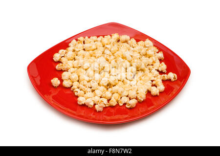 Popcorn on red plate isolated on white Stock Photo
