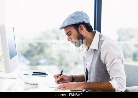 Side view of man taking notes Stock Photo