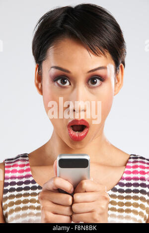 Woman Reading Text Message With Shocked Expression Stock Photo