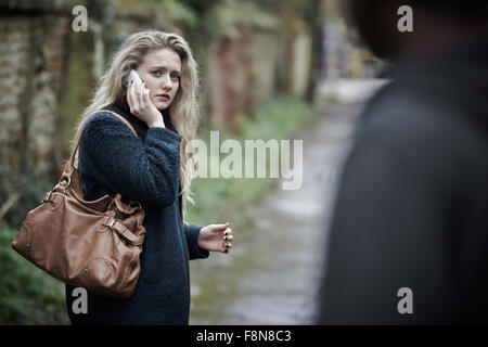 Young Woman Feeling Threatened As She Walks Home Stock Photo