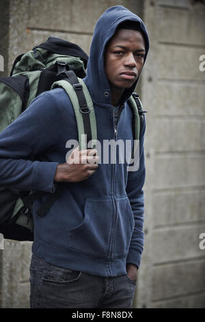 Homeless Teenage Boy On Streets With Rucksack Stock Photo