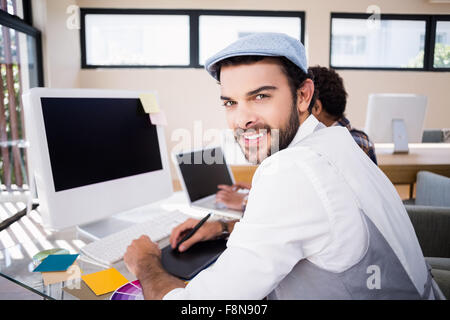 Smiling man using digital board Stock Photo