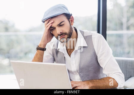 Worried man using laptop Stock Photo