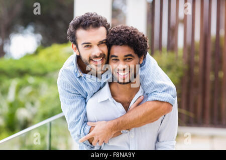 Portrait of smiling gay couple hugging Stock Photo