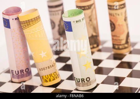 Dollars and Euro banknotes on chess board Stock Photo
