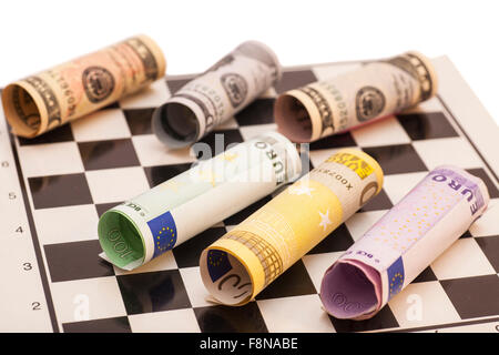 Dollars and Euro banknotes on chess board Stock Photo