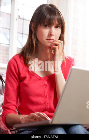 Worried Looking Woman Using Laptop Stock Photo