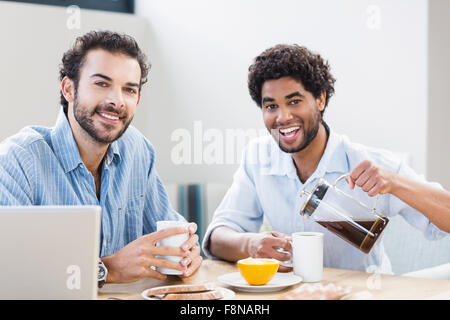Happy gay couple having breakfast Stock Photo
