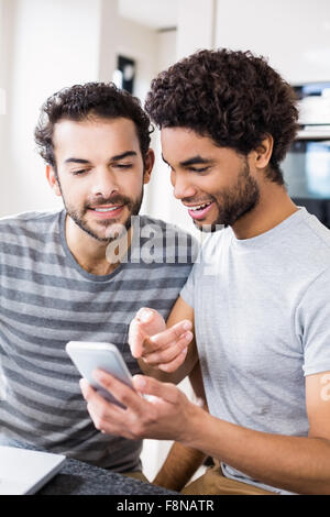 Happy gay couple using smartphone Stock Photo