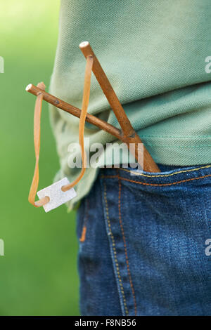 Close Up Of Slingshot In Boy's Trouser Pocket Stock Photo