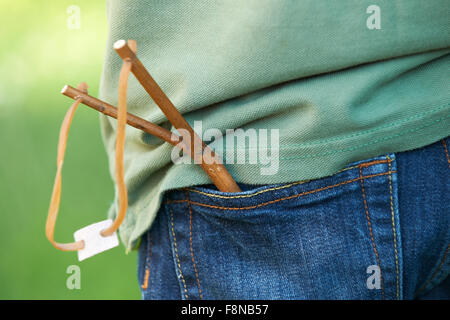 Close Up Of Slingshot In Boy's Trouser Pocket Stock Photo