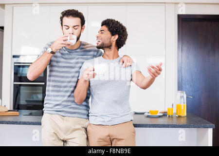 Happy gay couple having breakfast and talking Stock Photo