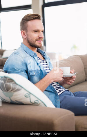 Casual man drinking tea on sofa Stock Photo
