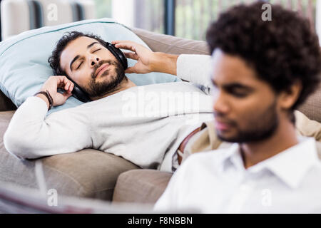 Handsome man using headphones Stock Photo