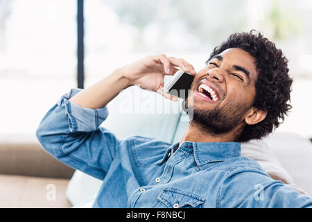 Handsome man on phone call laughing Stock Photo