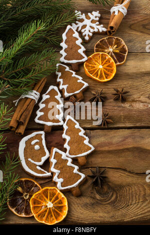 Christmas gift icing gingerbread, snowflake, fir tree and crescent cookies with cinnamon, anise, fruit slices, fir branches on a Stock Photo