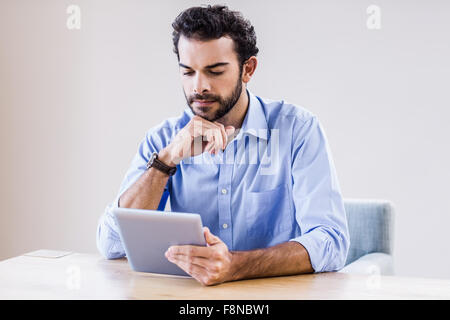 Serious man using tablet Stock Photo