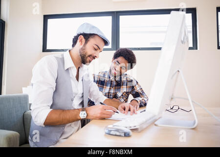 Smiling gay couple working Stock Photo