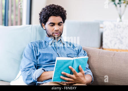 Handsome man reading book Stock Photo
