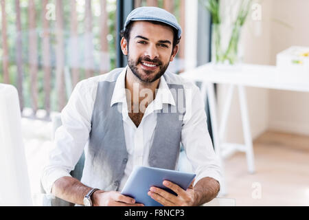 Handsome man holding tablet Stock Photo