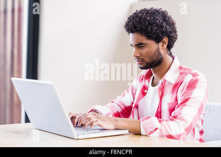 Serious man using laptop Stock Photo