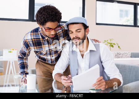Gay couple reading document Stock Photo