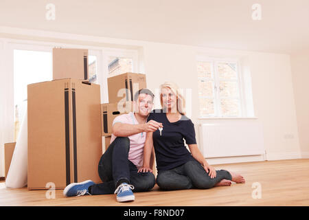 Couple Celebrating Moving Into New Home With Champagne Stock Photo