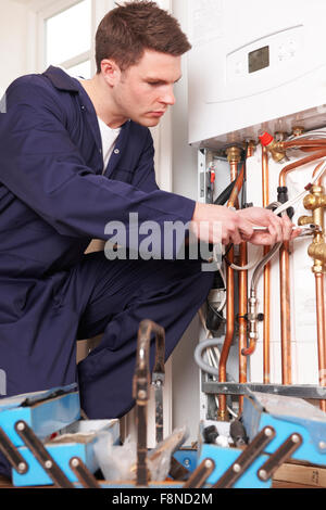 Engineer Servicing Central Heating Boiler Stock Photo