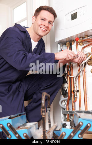 Engineer Servicing Central Heating Boiler Stock Photo