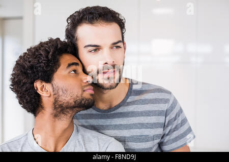 Happy gay couple in kitchen Stock Photo