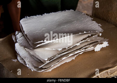 Stack of paper sheets in an ancient paper mill. Old traditional process of paper production Stock Photo